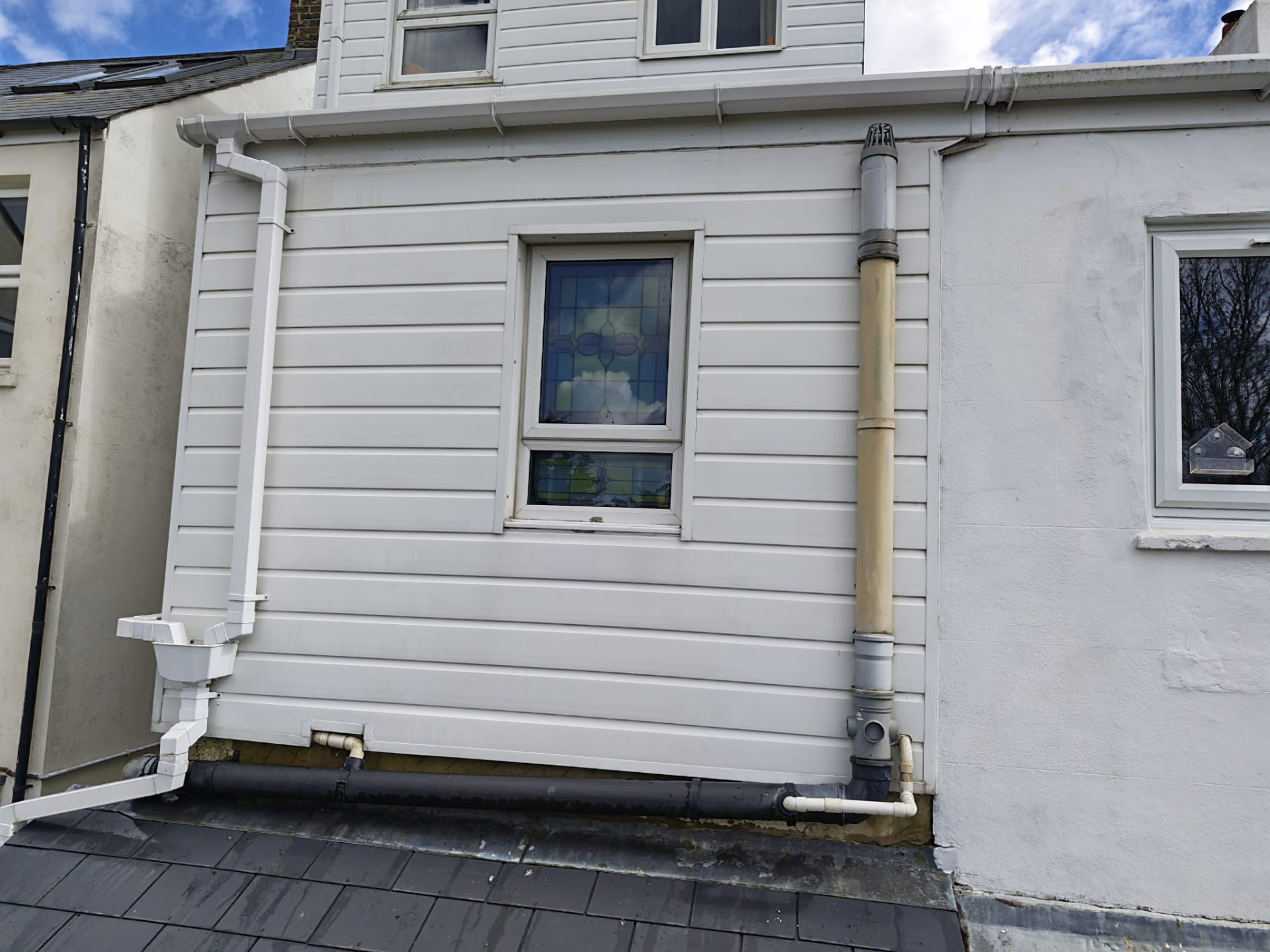 Clean white exterior cladding after treatment by OOR External