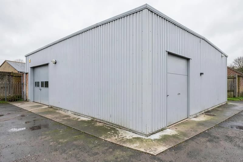 Profiled metal cladding on a light grey industrial unit