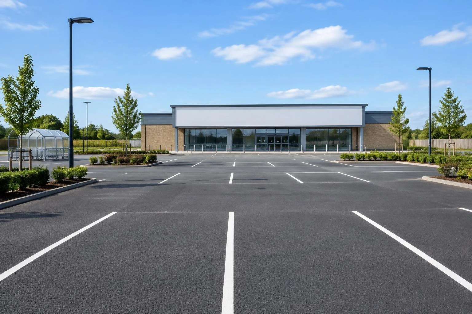 Black asphalt commercial car park with white parking bay markings
